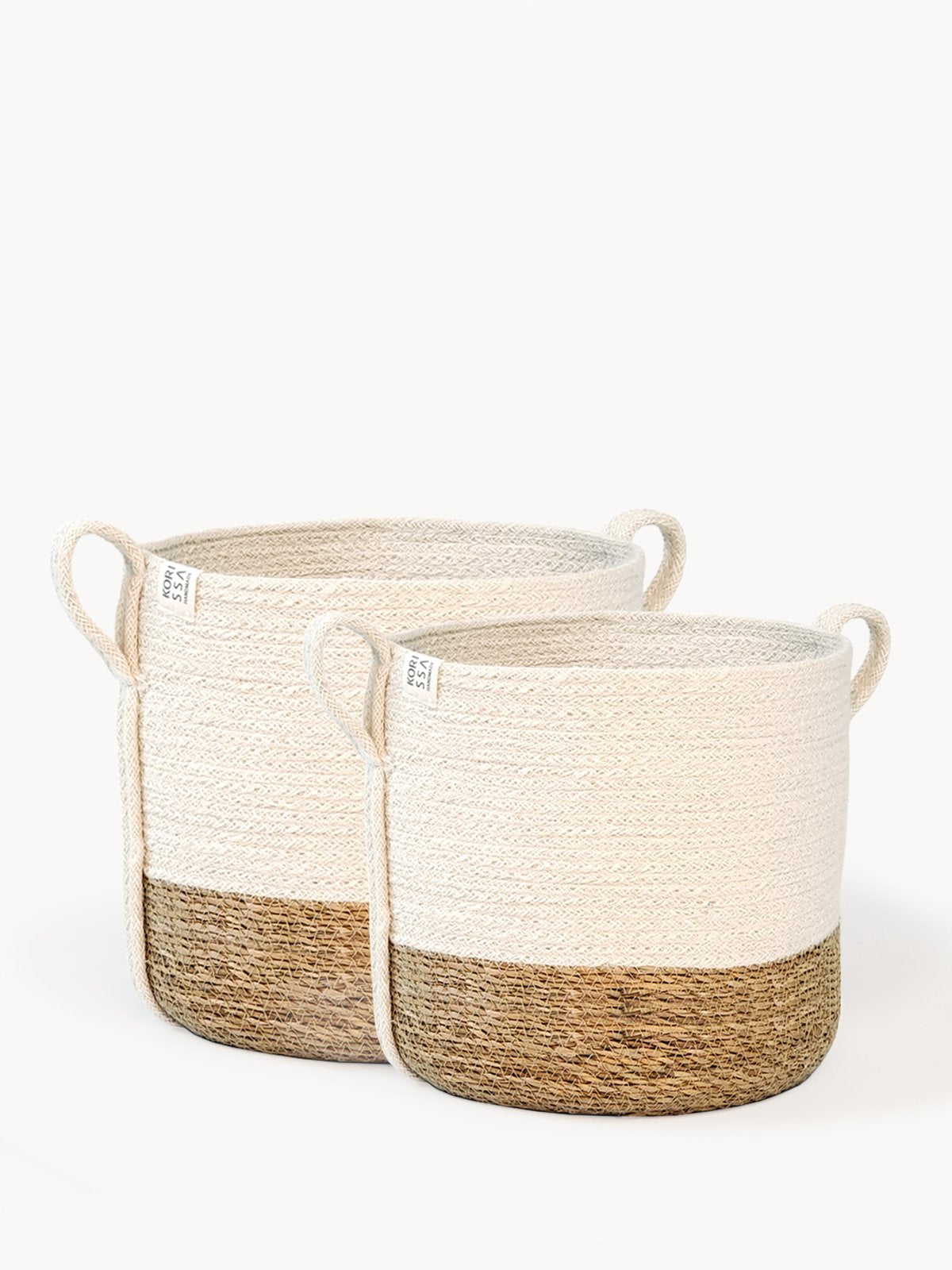 Two woven baskets with natural and white color scheme on a white background