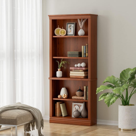Wooden bookshelf with decorative items in a room with a plant and ottoman.
