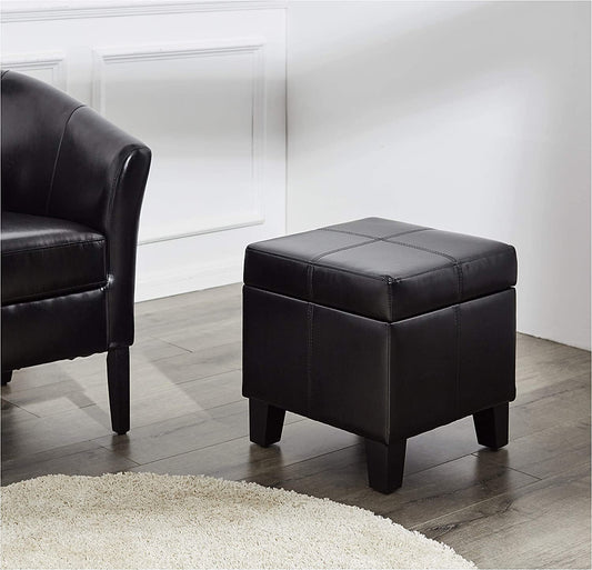 Black leather ottoman in a room with a black chair and white walls.