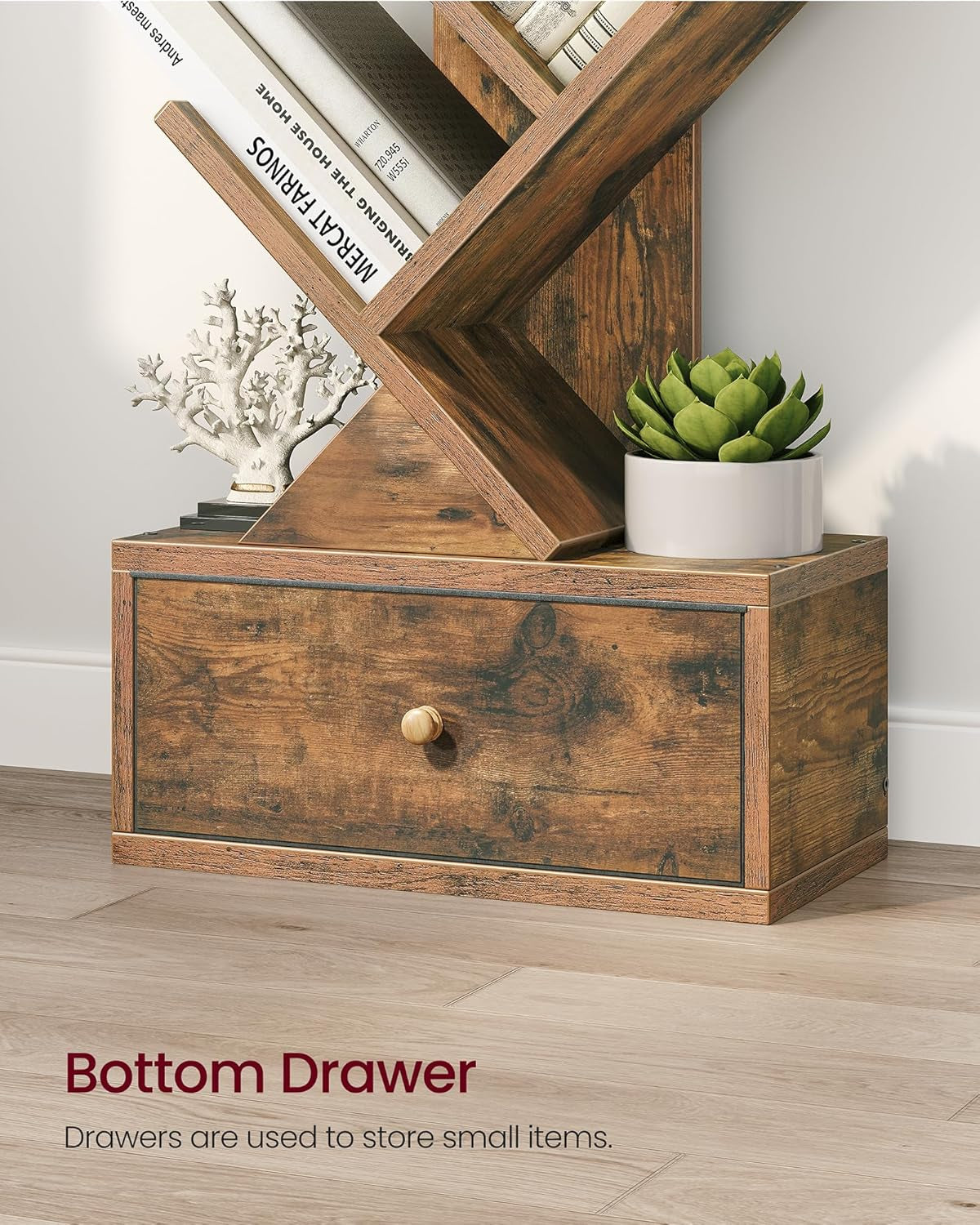 Wooden drawer unit with a plant and decorative items on a light wood floor.