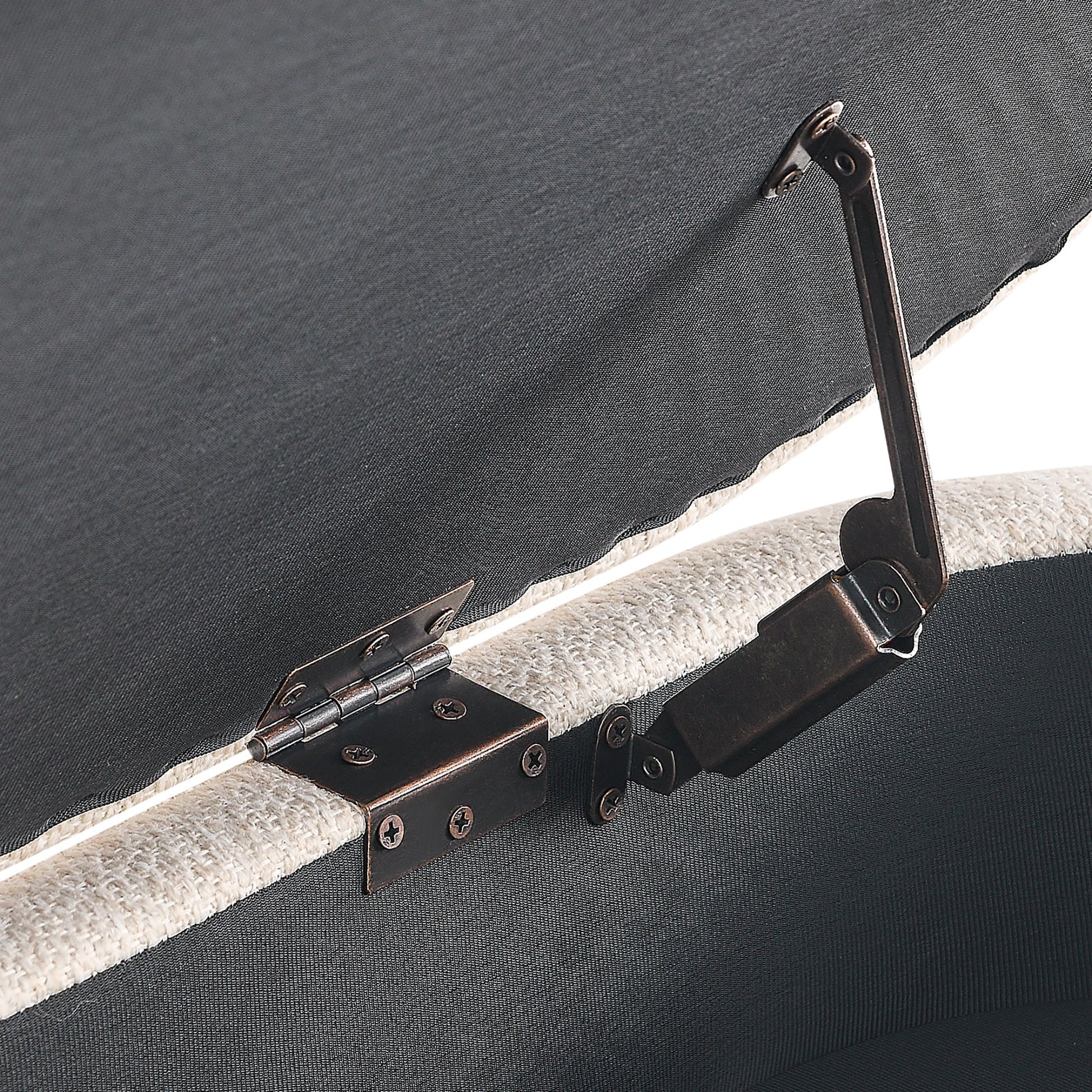 Close-up of a black metal bracket on a gray surface