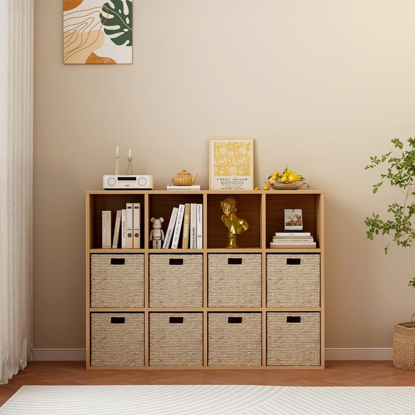 Wooden bookshelf with storage bins in a room with a plant and framed pictures.