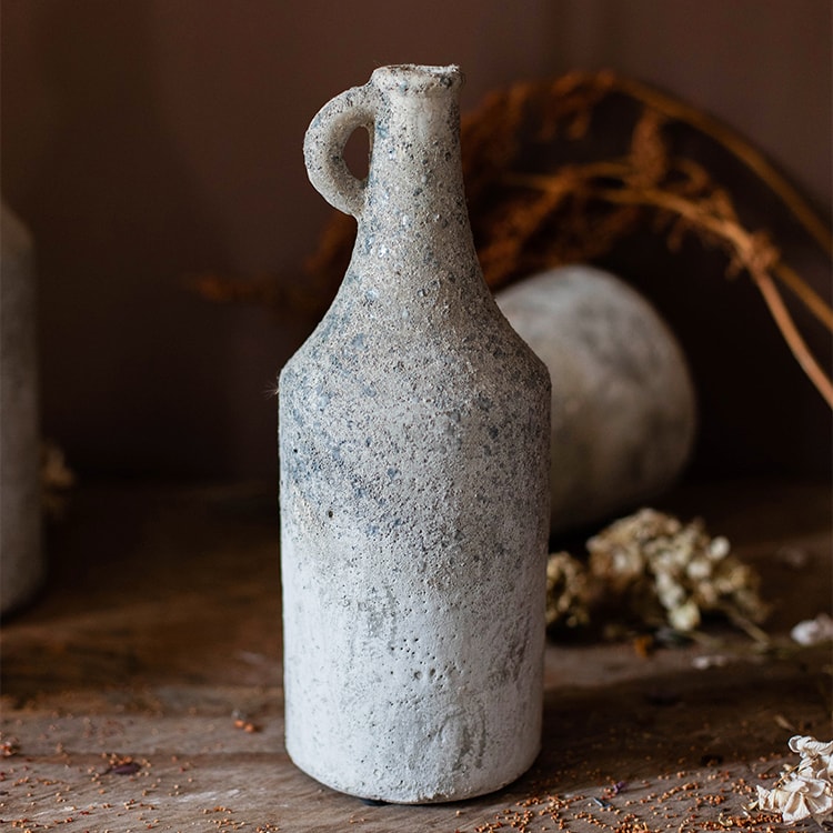 Textured ceramic bottle on a wooden surface with a blurred background