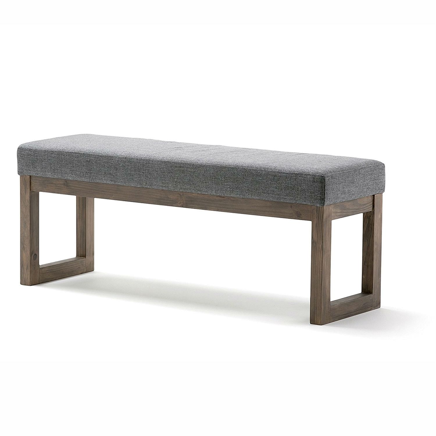 Gray upholstered bench with wooden frame on a white background