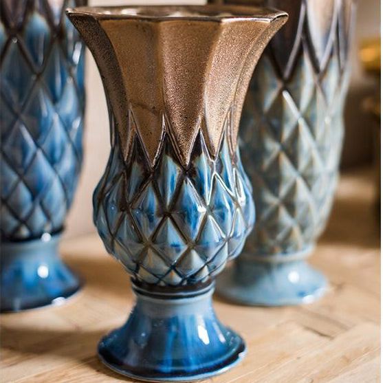 Ceramic vases with blue and brown patterns on a wooden surface