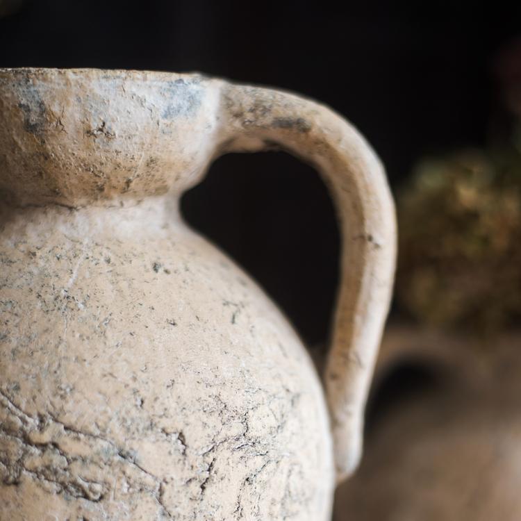 Close-up of an ancient clay pot with a blurred background