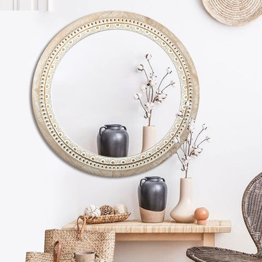 Decorative mirror with ornate frame on a wall above a shelf with vases and decor items.
