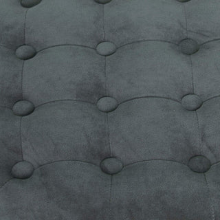 Close-up of a tufted gray fabric surface with button details